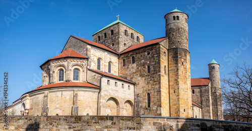 UNESCO St. Michael's Church, Hildesheim. Medieval Romanesque architecture exterior featuring iconic towers and stone facade. Famous historic landmark and pilgrimage site in Germany.