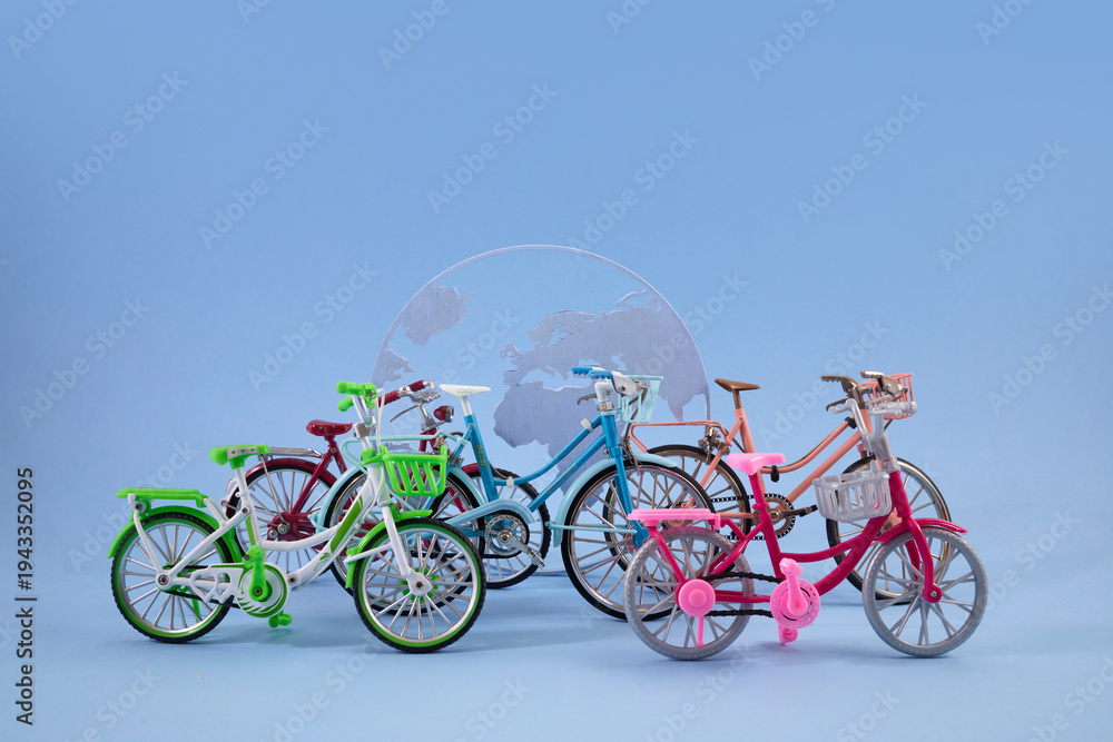 Fototapeta premium World Bicycle day. Bicycles in front of globe representing global sustainable transport