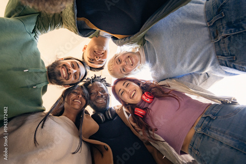 young multicultural students looking down smiling in circle friendship and community concept