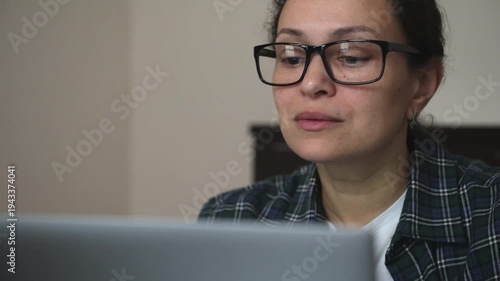 Focused Woman Working on Laptop at Home