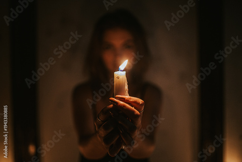 Woman Holding Burning Candle – Hope and Light Concept
