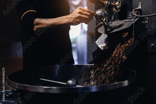 Tableau sur toile Coffee roaster operator pouring beans into cooling drum