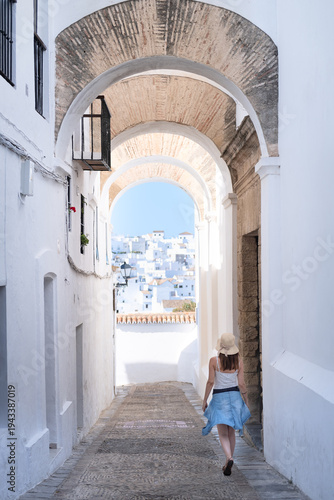 Young woman in summer dress walking through Vejer de la Frontera