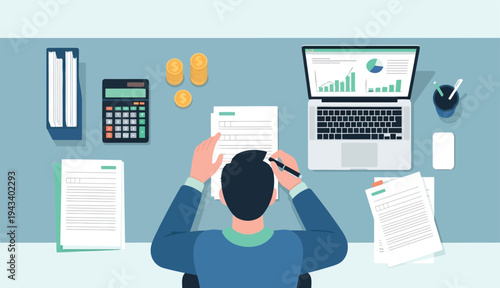 Man working at office desk with laptop and financial documents from above view