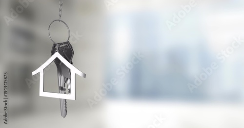 Hanging metal keyring with house-shaped charm and keys on chain in modern interior, copy space