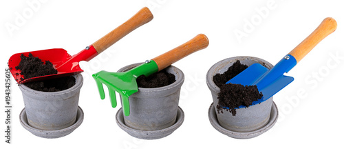 Small and colorful tools for transplanting flowers from a pot full of soil. Isolated background.