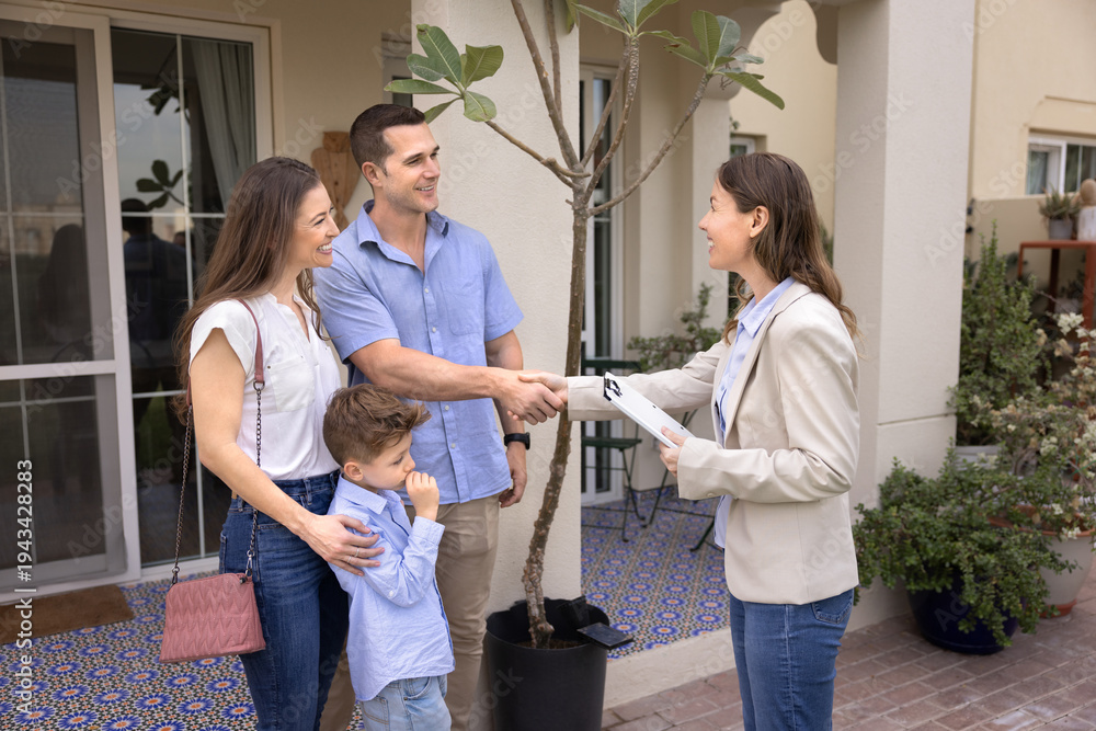 Fototapeta premium Smiling realtor agent handshake married couple with kid stand inside cottage house backyard. Successful professional services, closing real estate deal, property ownership, home buying, accommodation