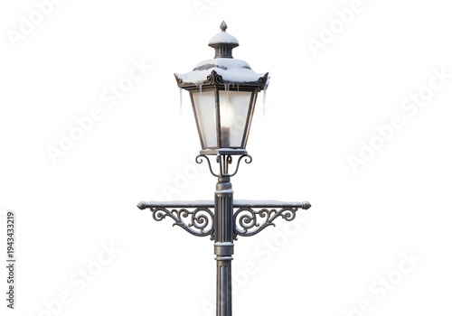 Snowy vintage street lamp post with ornate ironwork on white background