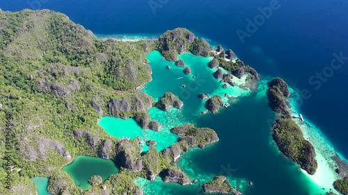 High altitude aerial view of Kabui with dramatic limestone cliffs and turquoise waters in Raja Ampat