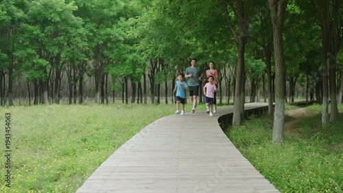 Wallpaper Mural Young family enjoying a morning jog together in the park Torontodigital.ca