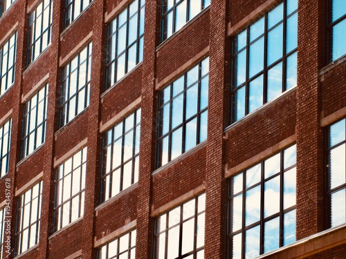 Tableau sur toile reflective windows of an old brick building