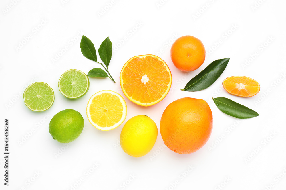Fototapeta premium Different fresh citrus fruits and green leaves on white background, flat lay