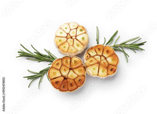 Foto Grilled garlic bulbs with rosemary isolated on white, top view