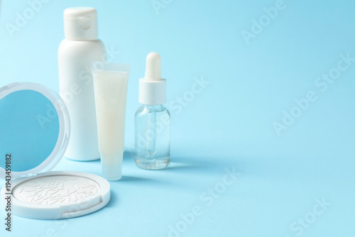 Konstfotografi Different makeup products on light blue background, closeup