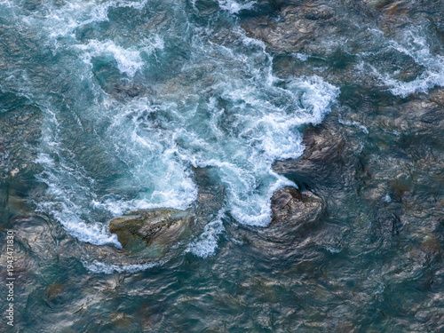 Aerial View of Turquoise River Rapids Crashing Over Rocks in Wild BC Canada Landscape
