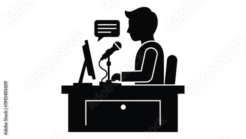 A man sitting at a desk with a microphone