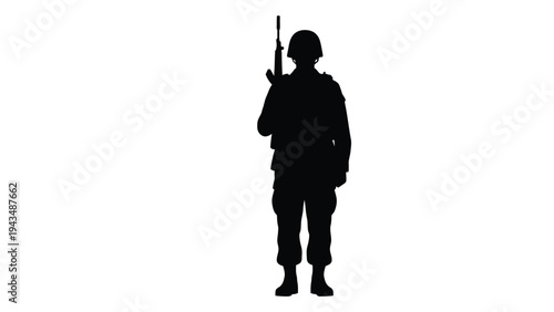 A soldier is standing and holding a rifle