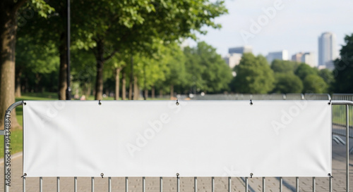Large white banner on fence outdoor.
