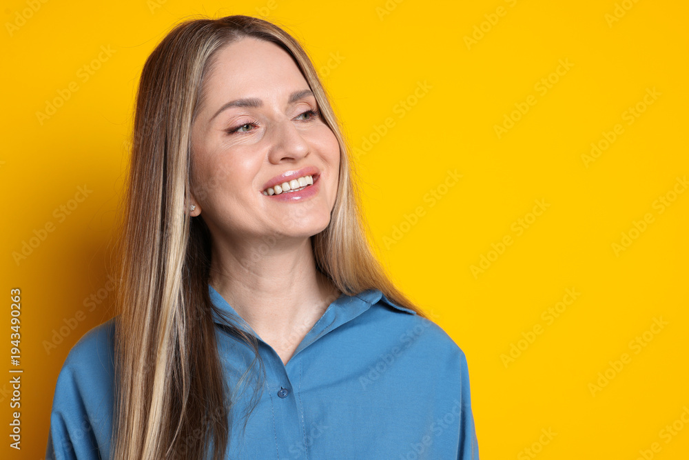 Fototapeta premium Portrait of beautiful woman on yellow background, space for text