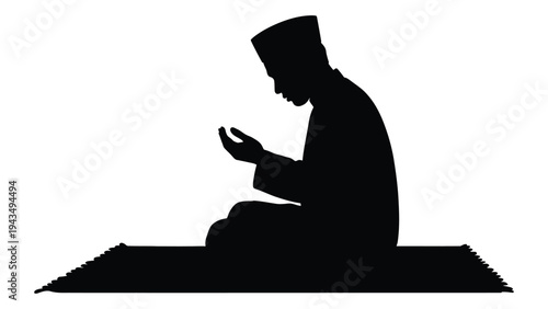 A man sitting on a mat with his hands in prayer