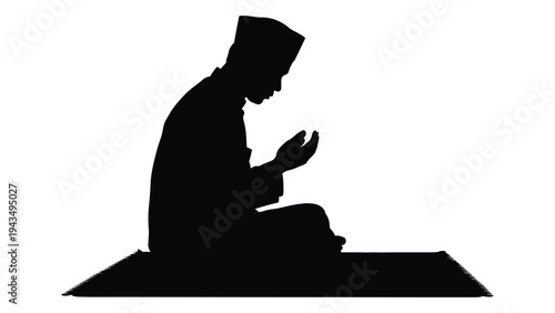 A man sitting on the ground praying