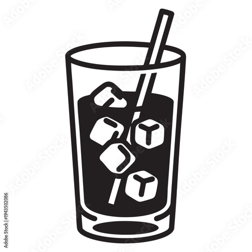 A glass of iced coffee with a straw in it on a table indoors.