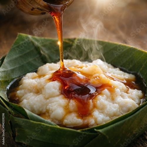 Pouring palm sugar syrup on hot traditional Indonesian bubur sumsum dessert, warm macro food photography for culinary menus.