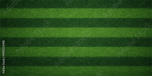 A vibrant green grass texture covers a professional soccer pitch where white stadium lines and artificial turf meet for a competitive sports game on an outdoor football field arena ground