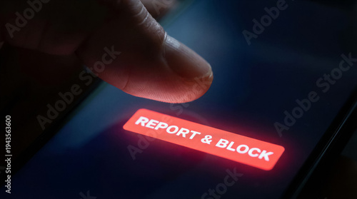 Wallpaper Mural A finger is poised to tap the glowing red "Report & Block" button on a smartphone screen, indicating a decisive action against unwanted content or contact. Torontodigital.ca