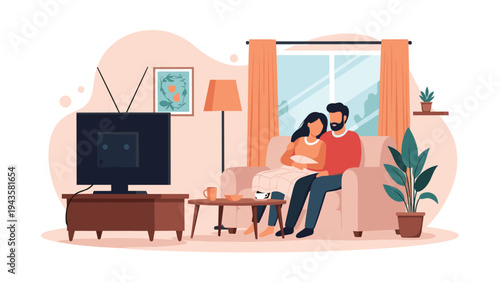 Romantic young couple relaxing on a sofa and watching television together at home under a warm cozy blanket.