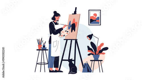 Creative female artist wearing an apron painting on a canvas in her studio accompanied by a cat and surrounded by art supplies.