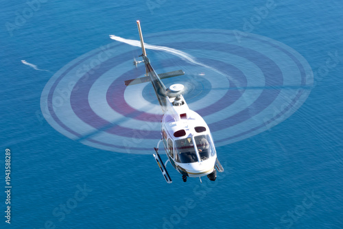 Konstfotografi Helicopter (Eurocopter AS350)  over the Pacific ocean at very low shutter speed