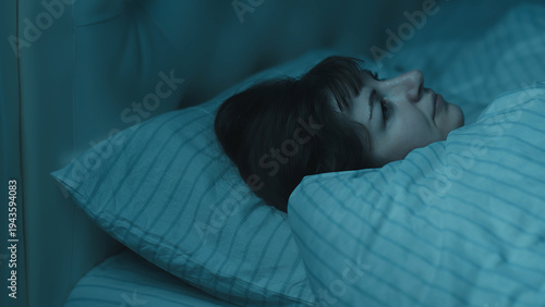 Obraz na płótnie Woman lying awake in bed at night with insomnia, have fun and enjoy