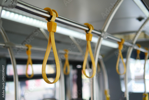 Hanging grips in a city bus during the day