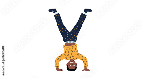 Young athletic boy performing a handstand on his hands with his legs in the air demonstrating balance and physical strength.