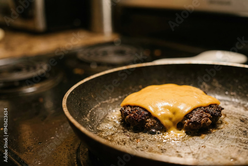 Beef Patty with Melted Cheddar Sizzling in Non-stick Pan on Stovetop