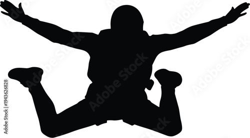 Silhouette of skydiver free-falling with arms and legs spread wide, helmet and parachute pack visible, representing dynamic aerial adventure