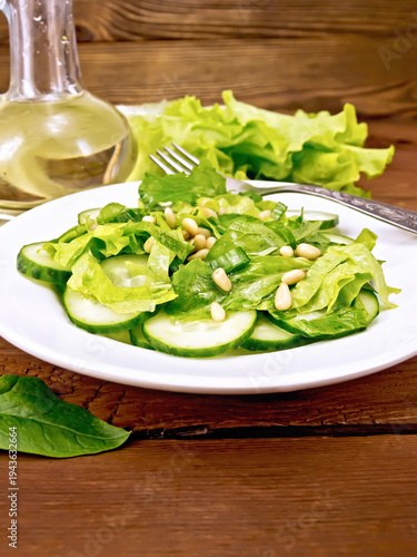 Salad from spinach and cucumber with lettuce on board