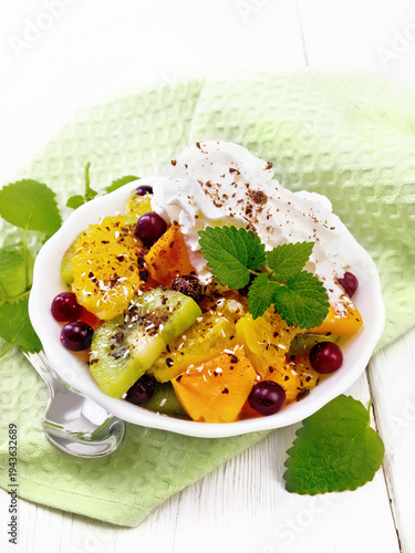 Salad fruit with cranberries in bowl on white board