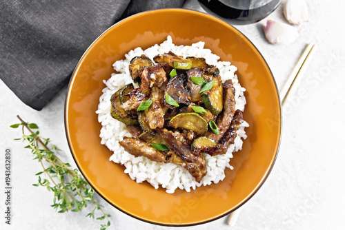 Stir-fried of chicken with zucchini in plate on stone top