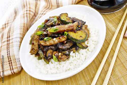 Stir-fried of chicken with zucchini in plate on bamboo napkin