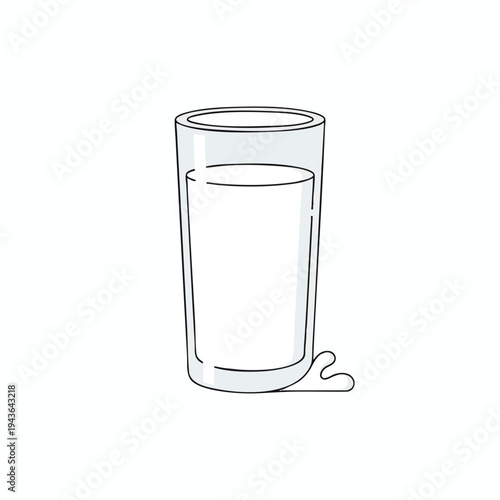A clear glass with milk and a small spill