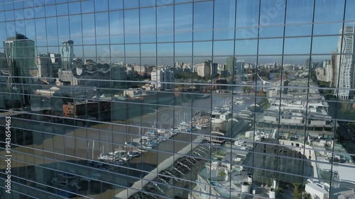 City view from tall building with reflections and river in the background
