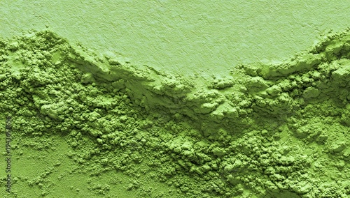 A textured surface of green powder, showcasing a variety of shades and granular details.