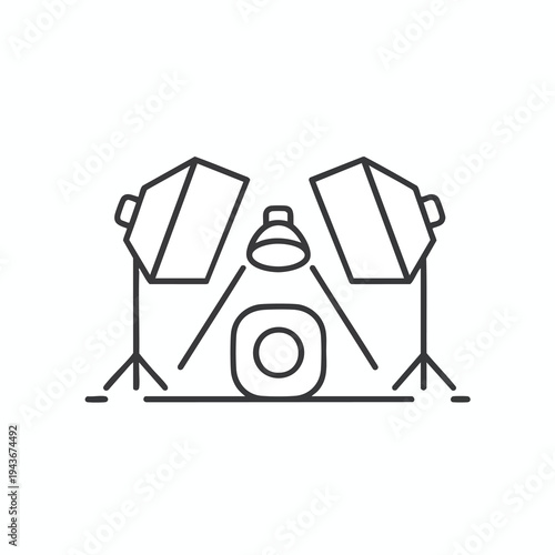 Two studio lights flank a camera for professional product or portrait photography