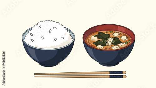 Traditional Japanese breakfast set featuring a bowl of white rice, miso soup with seaweed and tofu, and chopsticks.