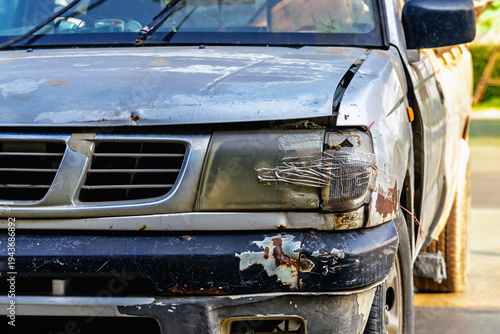 Broken headlight on car and sealed with transparent tape. Broken car headlight repaired with scotch tape. Headlight of damage car by accident and covered with transparent duct tape, broken, repair