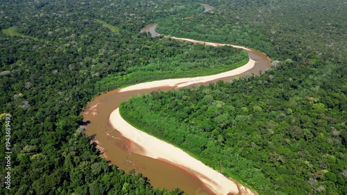 Aerial drone footage of morning mist rising over the Amazon rainforest canopy in Tambopata, Madre de Dios, Peru. Dense tropical jungle landscape covered in fog at sunrise