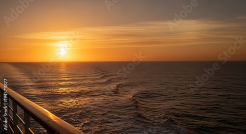 View from a vessel as the sun sets over a calm, rippled ocean
