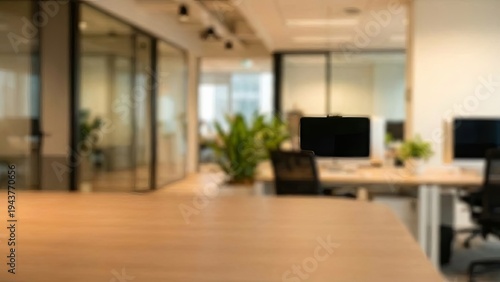Modern office interior with desks and plants with blurred background.